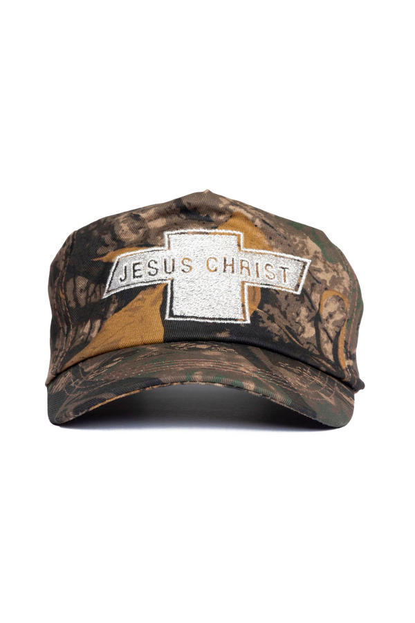 Camouflage cap with 'Jesus Christ' text and cross symbol on a white background